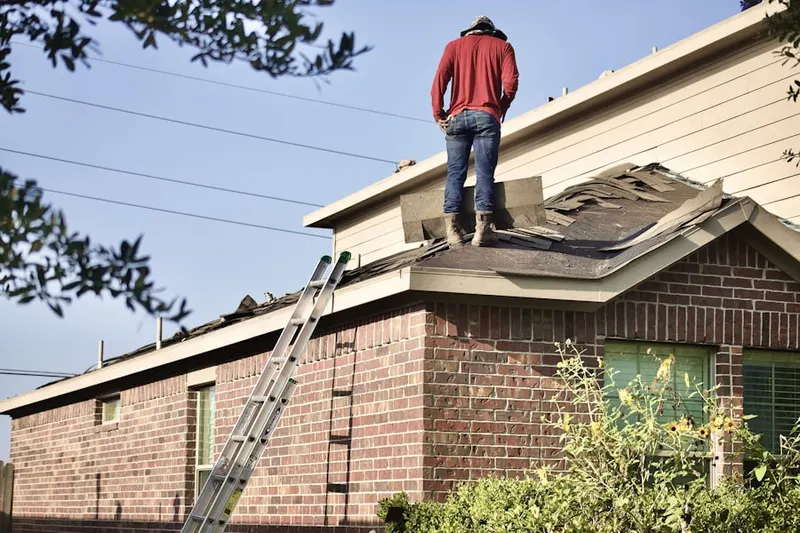 Professional roofer working on a residential roof in Sandestin